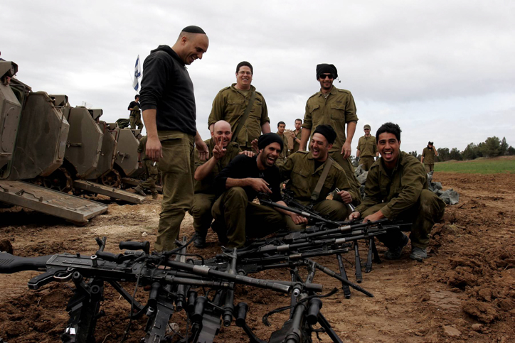 Israeli soldiers meet on Israeli-Gaza border after returning from Gaza Strip