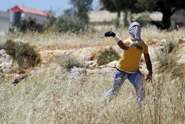 In the eyes of the Western media, Palestinian children do nothing but throw stones all day. A Palestinian demonstrator hurling rocks in protest. Photo: Flash90