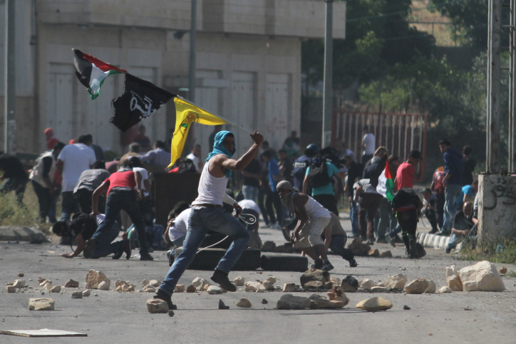 The only part of Palestinian life shown in the media. A Palestinian riot near Betunia. Photo: Flash90