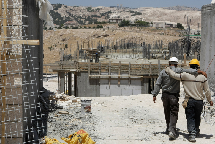 Palestinian labourers work at a construction site in the city of Maaleh Adumim