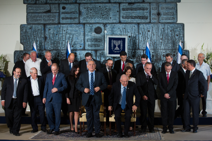 Israel's President Reuven Rivlin (L, seated) sits next to Prime Minister Benjamin Netanyahu (R, seated) as they pose for a group photo together with the ministers of the new Israeli government, in Jerusalem, 19 May 2015. Photo by Yonatan Sindel/Flash90 *** Local Caption *** ??????? ??? ????? ????? ????? ?????? ??? ????? ???? ???? ?????? ?????? ??? ?????? ????? ?????? ???? ??????